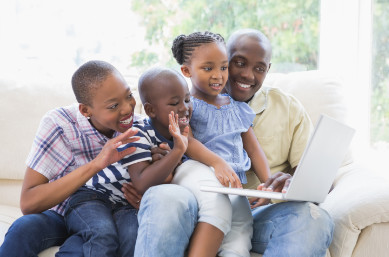 Family gathered around computer